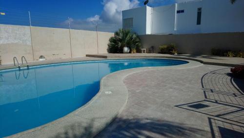une piscine en face d'un bâtiment dans l'établissement Beach house in Punta Carnero Salinas / Casa, à Salinas