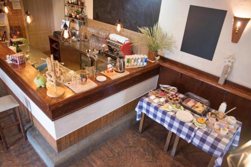 a restaurant with a counter with food on a table at Bed & Breakfast Dvorec in Petrovče