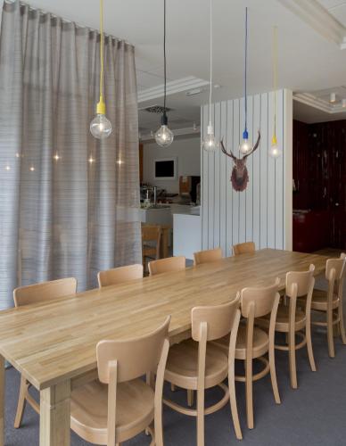 a dining room with a wooden table and chairs at Holiday Inn Express Antwerpen City North by IHG in Antwerp