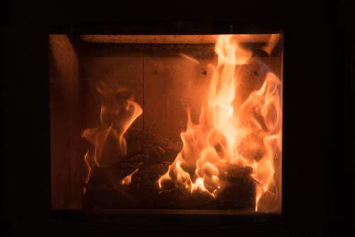 a fire in a brick oven with flames at Bed & Breakfast Dvorec in Petrovče