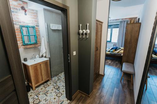 a bathroom with a shower and a sink in a room at Singer Retro Studio in Kazimierz in Kraków
