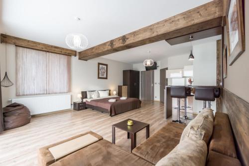 a large living room with a bed and a couch at Willa w Ubocy - "Jacuzzi i Sauna w ofercie dodatkowo płatnej" in Murzasichle