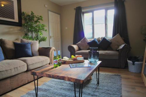 a living room with two couches and a coffee table at Hambleton House in Catterick Garrison