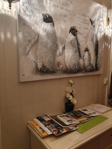 a picture of three penguins on a wall at Valhalla bengtfors Private house in Bengtsfors