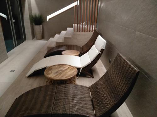 a room with two chairs and a table and a staircase at Glamour Apartment City View in Wrocław