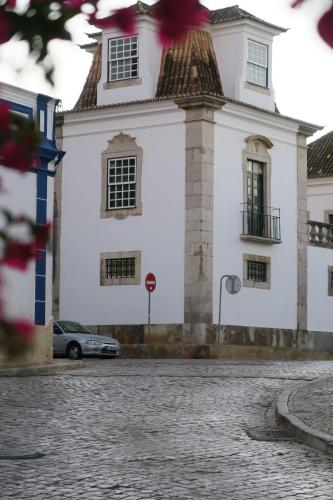 a white building with a car parked in front of it at Azul Sul in Tavira