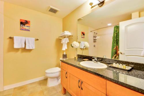a bathroom with a sink and a toilet and a mirror at Ski In Out Luxury Condo 4474 I Huge Hot Tub I Great Views I Best Price I FREE Adventures Daily in Winter Park