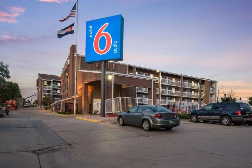a car parked in a parking lot in front of a building at Motel 6-Colorado Springs, CO - Air Force Academy in Colorado Springs
