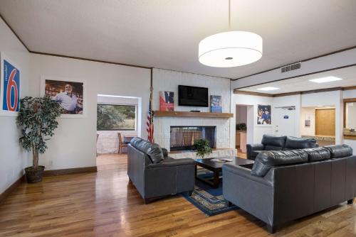 a living room with two couches and a fireplace at Motel 6-Colorado Springs, CO - Air Force Academy in Colorado Springs