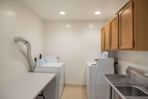 a kitchen with a sink and a washer and dryer at Studio 6 Colorado Springs, Colorado - Air Force Academy in Colorado Springs