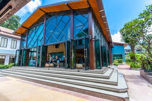 a large white building with a large window at ChaoKoh Phi Phi Hotel and Resort- SHA Extra Plus in Phi Phi Don