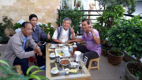 a group of people sitting around a table at Mai DaLat Homestay in Da Lat