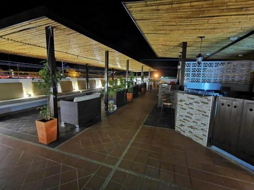a restaurant with a bar with tables and chairs at Apolonia Boutique in Guaduas