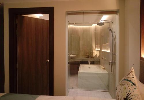 a bathroom with a shower and a bath tub at J7 Plaza Hotel in Iloilo City