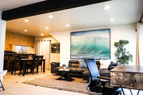 a living room with a couch and a table at Newport Beach House 1 blk to beach and 25 min to Disney in Newport Beach