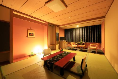 a living room with a bed and a dining room at Yutorelo Toyako in Lake Toya