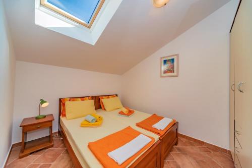 a bedroom with a bed and a skylight at Apartments Bigovo Veljic in Tivat