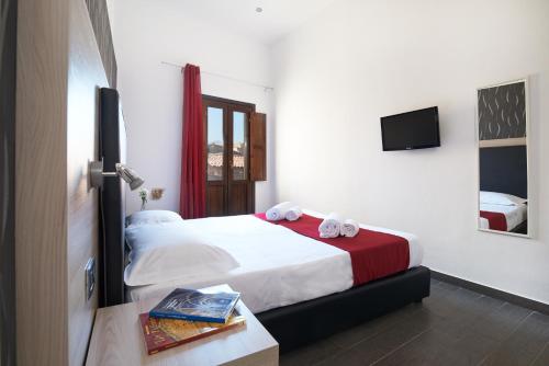 a bedroom with a bed with two towels on it at La Terrazza sul Centro in Palermo