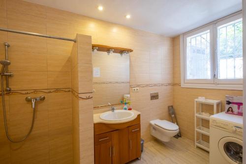 a bathroom with a sink and a toilet and a shower at Villa Montemar in Tossa de Mar