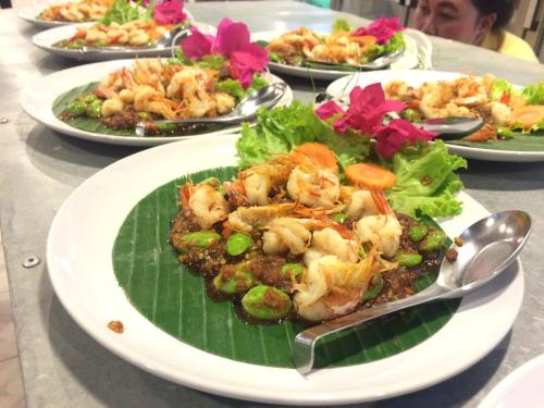 a plate of food with shrimp on a banana leaf at LayTrang Pakmeng Marina Spa and Resort in Trang