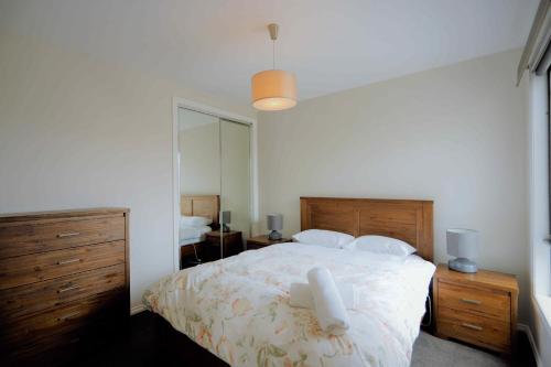 a bedroom with a bed and a dresser at Apollo Bay Seal Apartments in Apollo Bay