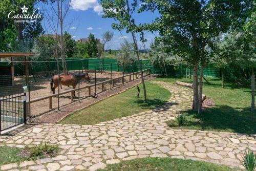 a horse in a fenced in area with a fence at Cascadas Family Resort in Sunny Beach