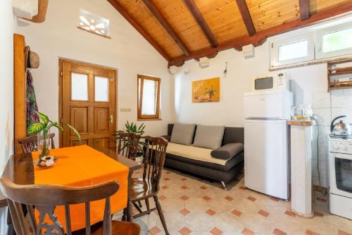 a kitchen and living room with a table and a refrigerator at Apartments Darija in Pučišća
