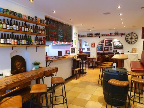 a restaurant with a bar and some tables and chairs at BrauHotel Bonn in Bonn