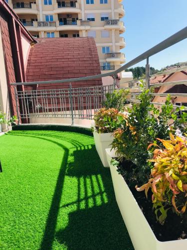 a balcony with green grass and plants on a building at VNVP Apartment in Štip