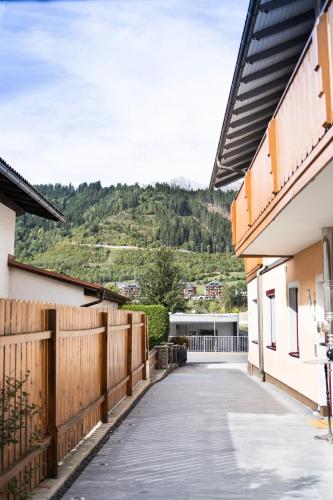 a walkway between two buildings with a fence at Ski in - Ski out Schladming NEM Alpin Chalet in Schladming