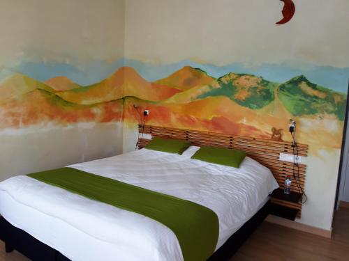 a bedroom with a large bed with a painting on the wall at Casa Lamberdina in Parroquia de la Fuensanta