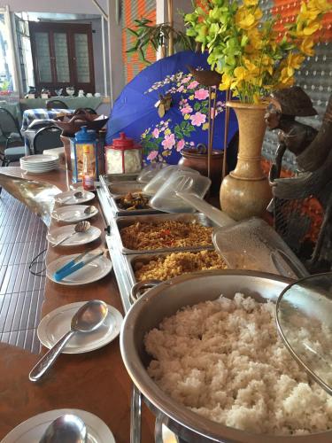 a buffet with many dishes of food on a table at Mandalawangi Hotel Syariah in Tasikmalaya