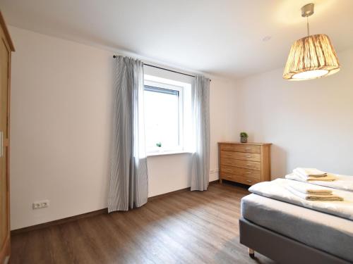 um quarto com uma cama e uma janela em Scenic Apartment in Insel Poel with Terrace em Insel Poel