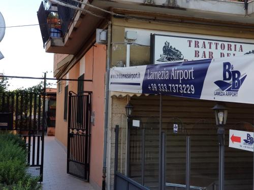 a building with a sign for a bar at B&B Lamezia Airport in Lamezia Terme