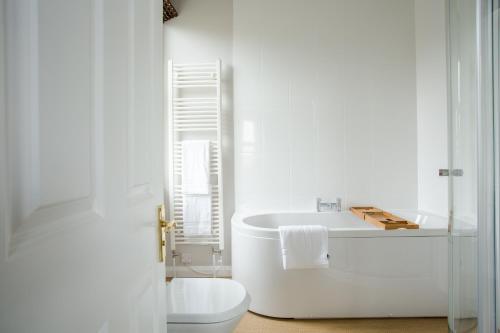 a white bathroom with a sink and a toilet at Grays Boutique B&B in Bath