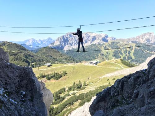 a person standing on a zip line in the mountains at Sonnleitn 29 in Sonnenalpe Nassfeld