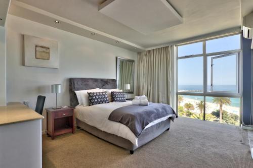 a bedroom with a bed with a view of the ocean at Cloud Nine by Totalstay in Cape Town