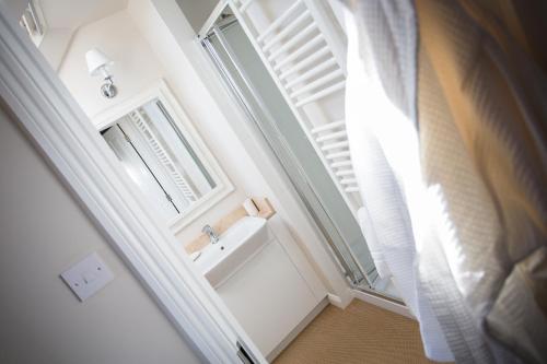 a bathroom with a sink and a window at Grays Boutique B&B in Bath