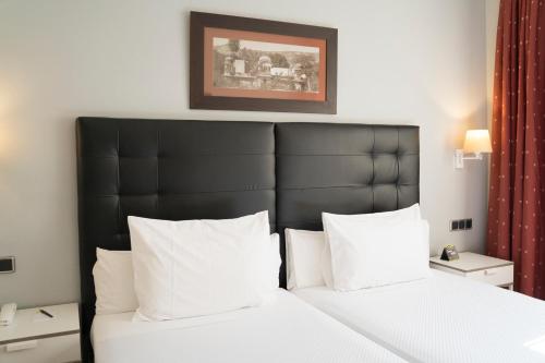 Posteľ alebo postele v izbe v ubytovaní Hotel Sercotel Tres Luces