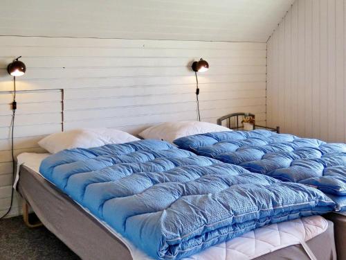 a bedroom with two beds with blue comforter at Two-Bedroom Holiday home in Lemvig 5 in Lemvig