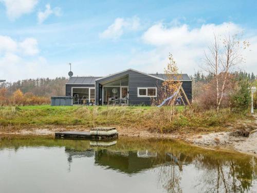 a house on the shore of a body of water at 10 person holiday home in Glesborg in Fjellerup Strand