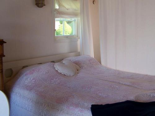 a small bed in a room with a window at 4 person holiday home in Rönnäng-By Traum in Rönnäng