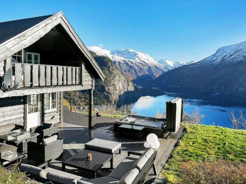 a house with a deck with a view of a lake at 8 person holiday home in Valldal in Valldal