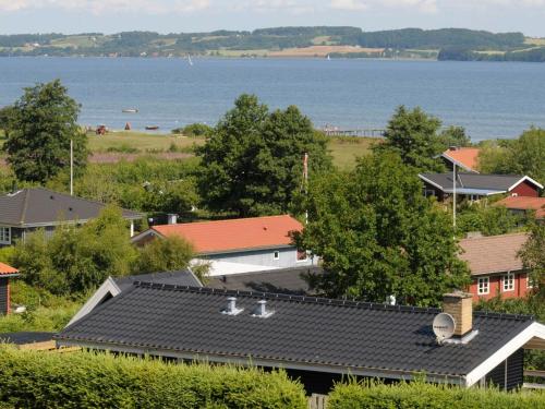 an overhead view of roofs of houses and the water at 5 person holiday home in B rkop in Egeskov