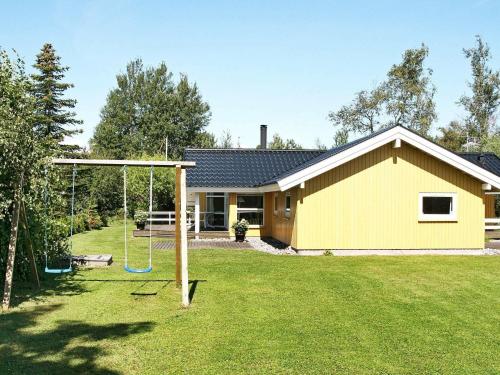 a house with a yard with a swing at 10 person holiday home in V ggerl se in Marielyst