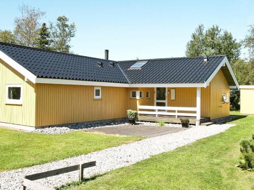 a yellow house with a black roof at 10 person holiday home in V ggerl se in Marielyst