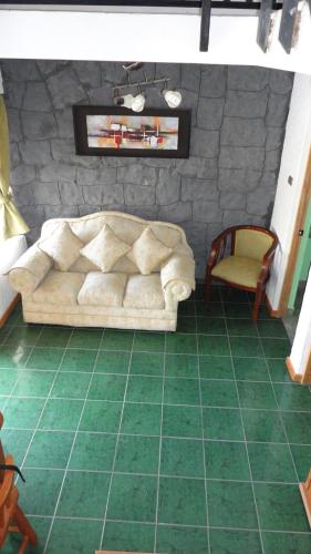 a living room with a couch and a chair at Cabañas Aires del Bosque in Concón