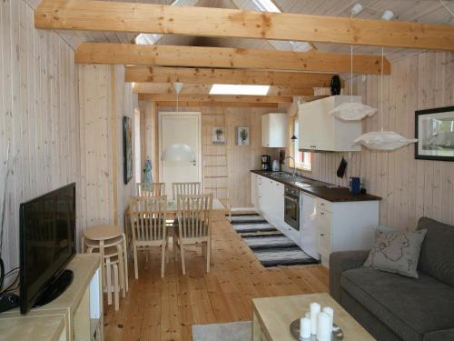 a kitchen and living room with a couch and a table at 4 person holiday home in Karreb ksminde in Karrebæksminde