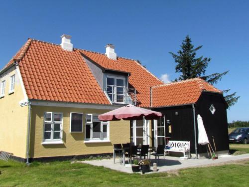 a small yellow house with an orange roof at 6 person holiday home in Skagen in Hulsig
