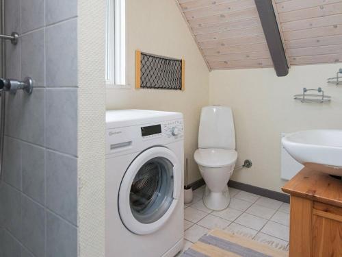 a bathroom with a washing machine and a toilet at Two-Bedroom Holiday home in Hejls 10 in Hejls